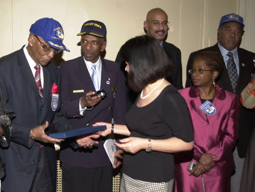 Tuskegee Airmen receive P-51 Mustang tie from Christina Cheng at the New York Wings Club